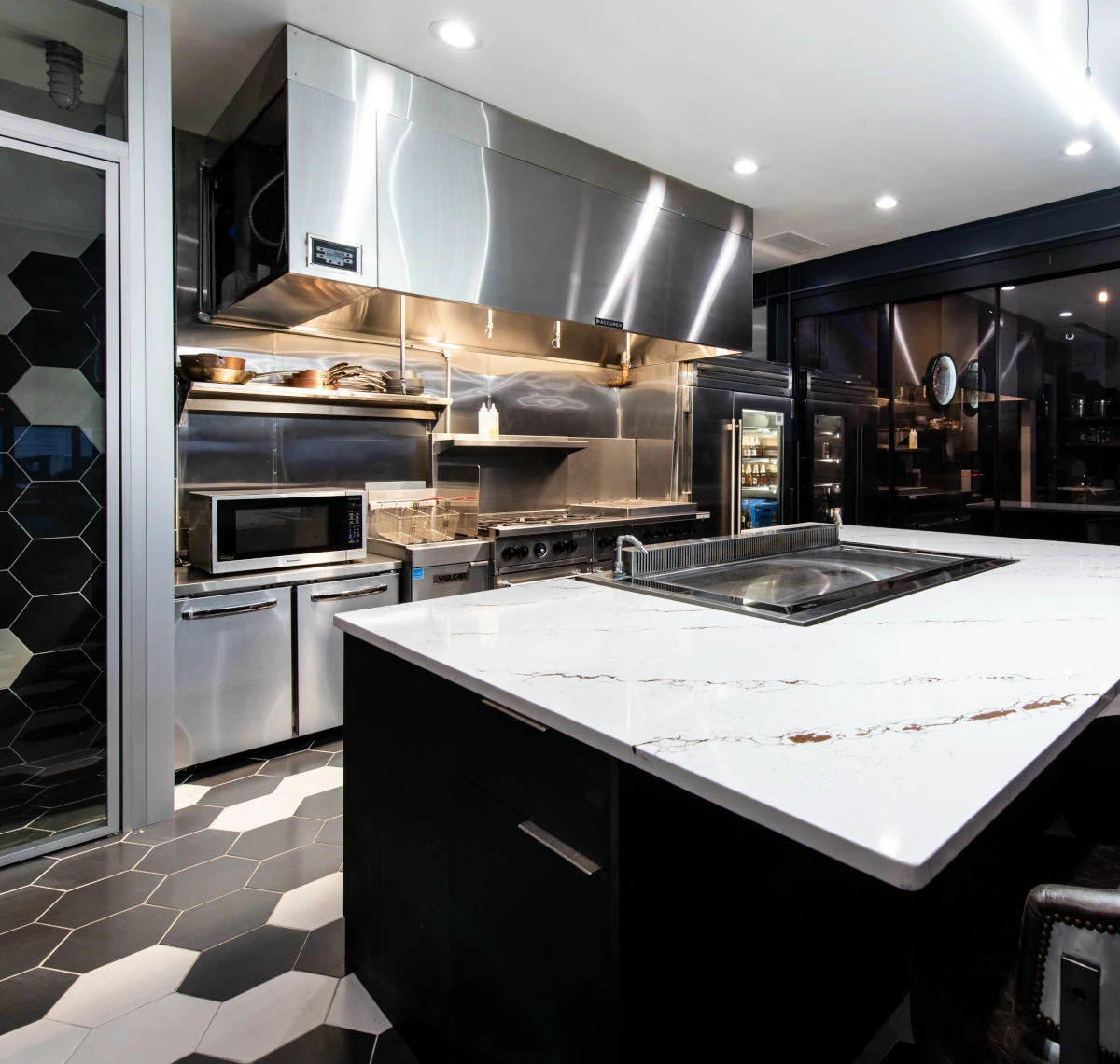 Commercial kitchen remodel with stainless countertops, custom cabinetry, and professional-grade appliances by Elite Cabinetry & Granite in Denver.
