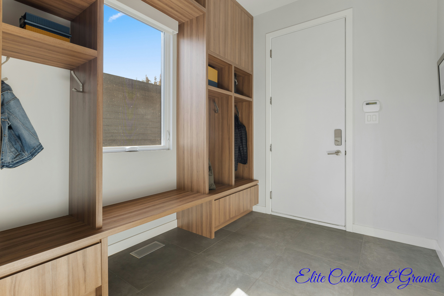 Why Your Denver Remodel Costs More Than Your Cousin’s in Phoenix (And What You Can Actually Control) 5 Custom mudroom built ins with wood cabinetry and natural light in a Denver home remodel that helps illustrate how Denver remodeling costs vary based on material and design choices.