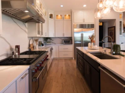 Luxury modern kitchen remodel featuring white cabinets, premium countertops and upscale appliances in Denver, highlighting factors that influence Denver remodeling costs