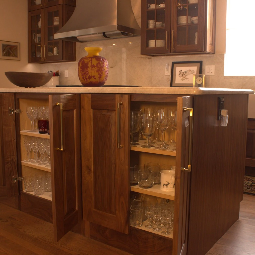 The Best Kitchen Storage Ideas for Denver Homeowners in 2026 7 walnut kitchen island stemware glassware storage