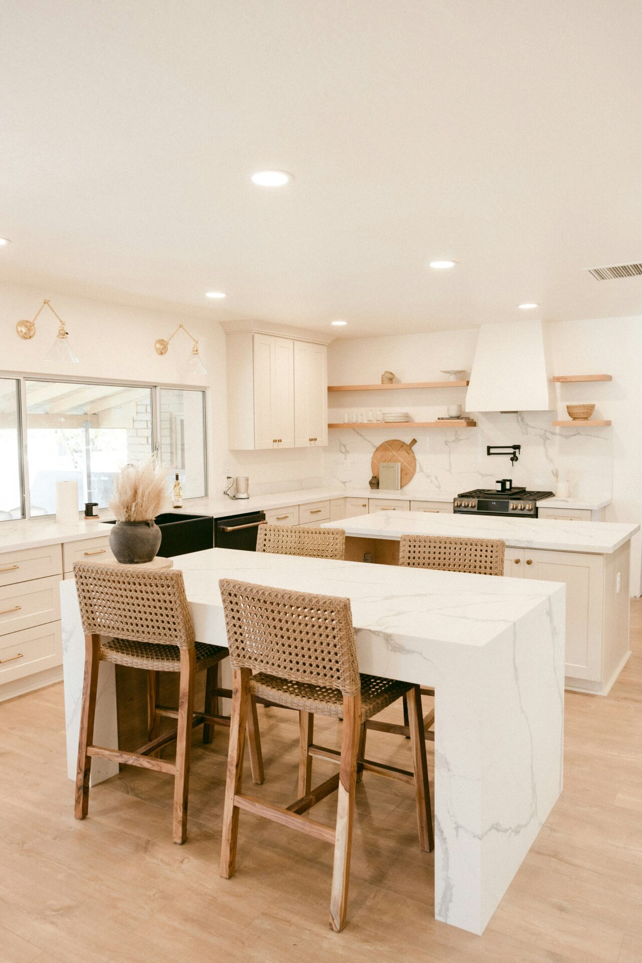 Your Denver Kitchen Remodel Guide: Custom Work, Fast Timelines, and a Kitchen You Will Actually Love 1 Denver kitchen remodel featuring custom cream cabinets, waterfall quartz island, floating wood shelves, and designer finishes.