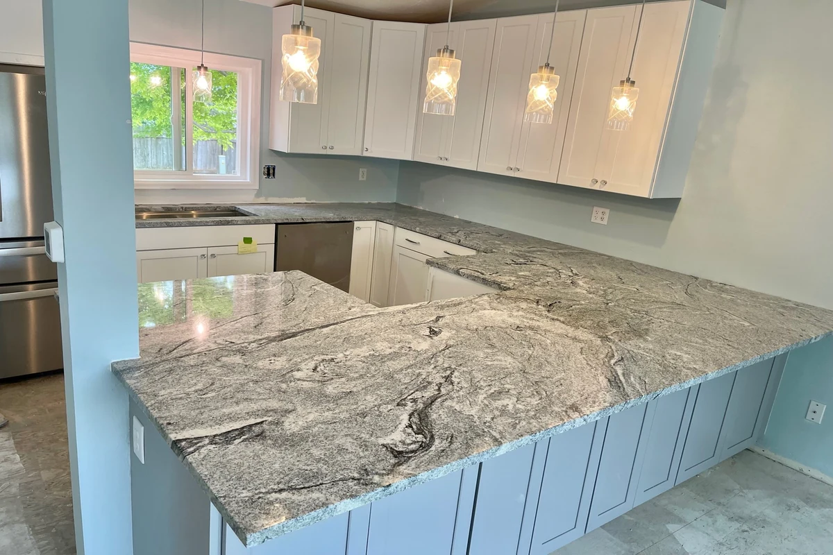 Your Denver Kitchen Remodel Guide: Custom Work, Fast Timelines, and a Kitchen You Will Actually Love 9 Finished kitchen featuring white shaker cabinets and granite countertops in a residential remodeling project.